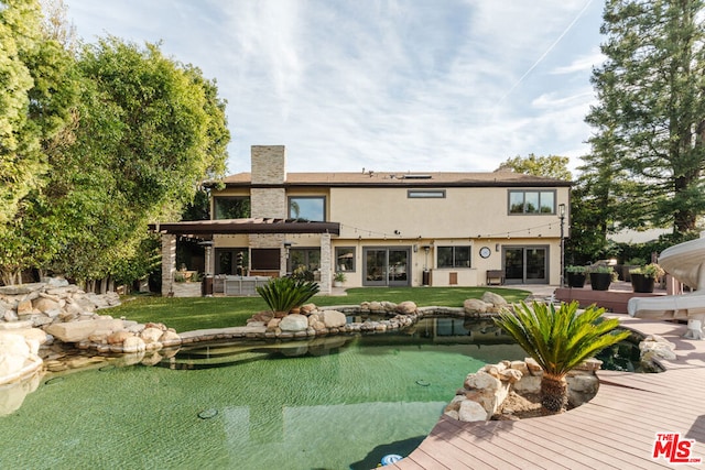 back of house featuring a yard, a pergola, and a patio