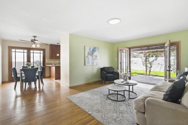 living room featuring hardwood / wood-style flooring and ceiling fan