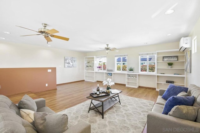 living room featuring wood-type flooring, a wall mounted AC, and ceiling fan