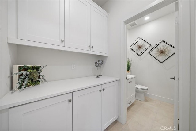 bathroom featuring vanity, toilet, and tile patterned flooring