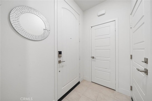 doorway with light tile patterned floors