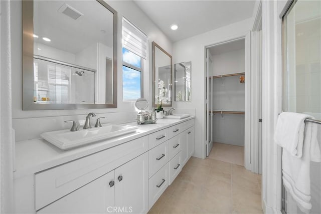 bathroom featuring an enclosed shower, vanity, and tile patterned flooring