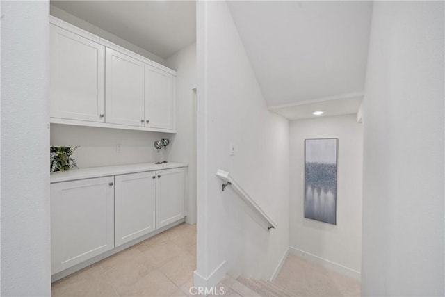 stairway with tile patterned flooring