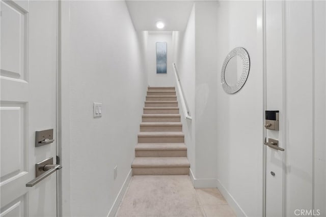 stairs featuring tile patterned flooring