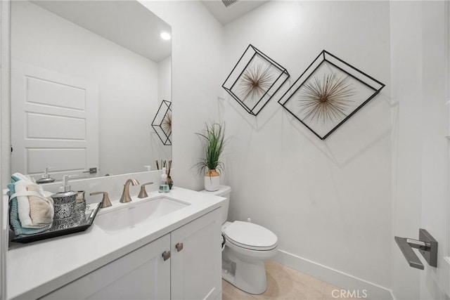 bathroom with vanity, tile patterned floors, and toilet