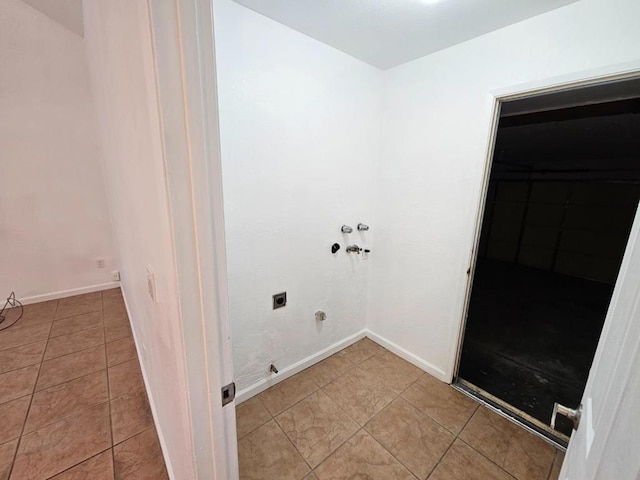 laundry area featuring hookup for a washing machine, hookup for an electric dryer, and light tile patterned floors