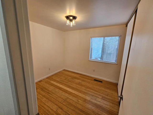 unfurnished room with light hardwood / wood-style flooring