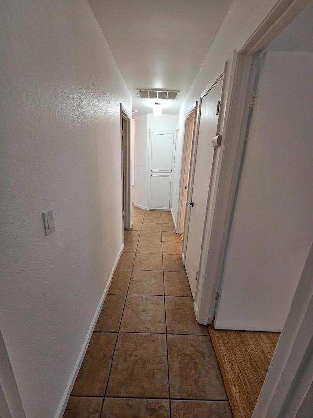 hallway featuring light tile patterned floors