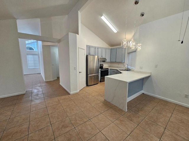 kitchen with light tile patterned floors, appliances with stainless steel finishes, high vaulted ceiling, decorative light fixtures, and kitchen peninsula