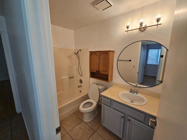 full bathroom with vanity, bathtub / shower combination, tile patterned floors, and toilet