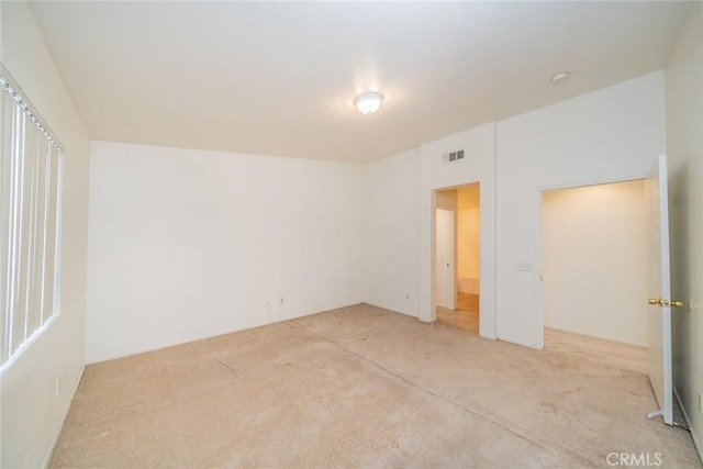 unfurnished bedroom with light colored carpet