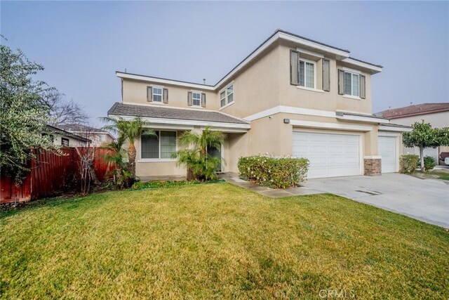 view of property featuring a garage and a front yard