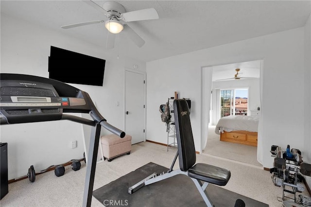 workout room featuring ceiling fan and light colored carpet