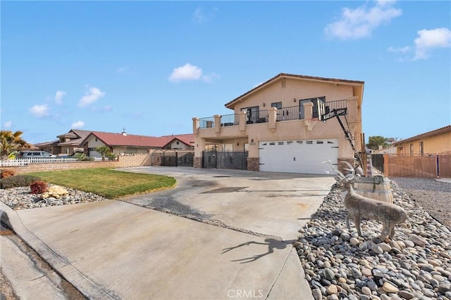 view of front of property featuring a balcony and a garage