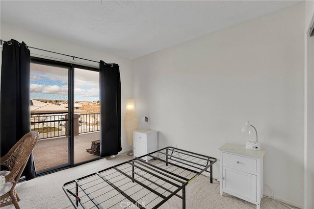 carpeted bedroom featuring access to outside