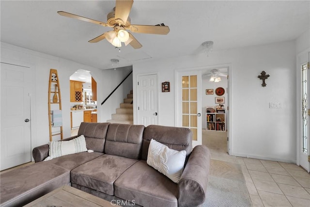 living room featuring french doors, ceiling fan, and light tile patterned flooring