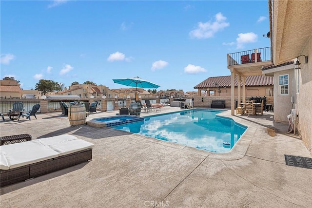 view of pool with a patio area and an in ground hot tub