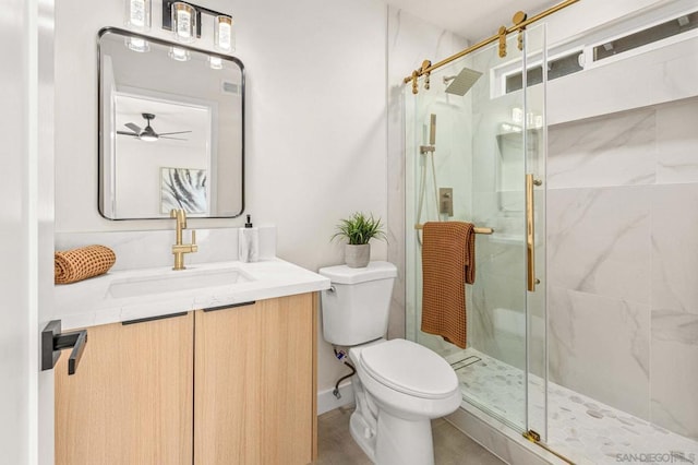 bathroom featuring an enclosed shower, vanity, toilet, and ceiling fan