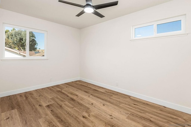 unfurnished room with hardwood / wood-style floors and ceiling fan