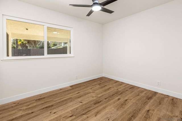 empty room with hardwood / wood-style flooring and ceiling fan