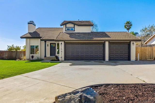 front facade with a garage and a front yard