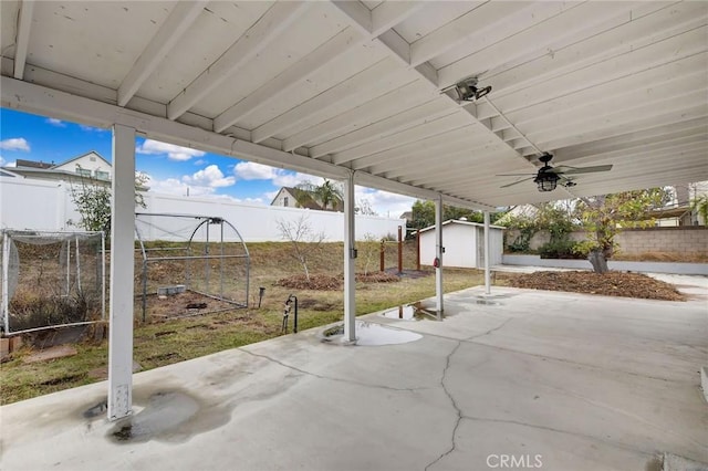 view of patio with a storage shed and ceiling fan