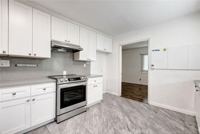 kitchen featuring white cabinetry, decorative backsplash, and stainless steel electric range oven