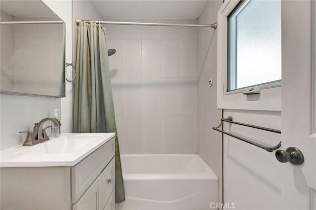 bathroom featuring vanity and shower / bathtub combination with curtain