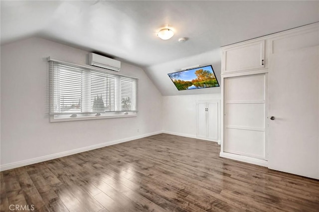 bonus room with vaulted ceiling, dark wood-type flooring, and a wall mounted air conditioner