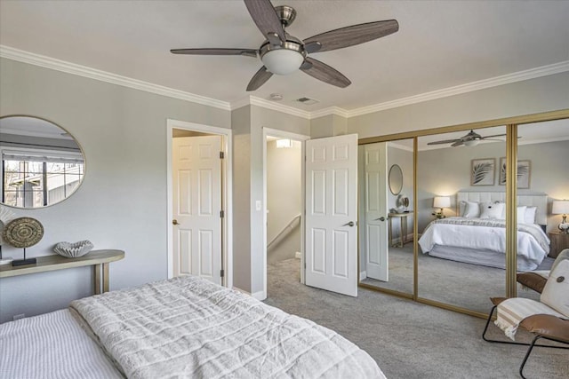 bedroom with light carpet, ornamental molding, a closet, and ceiling fan