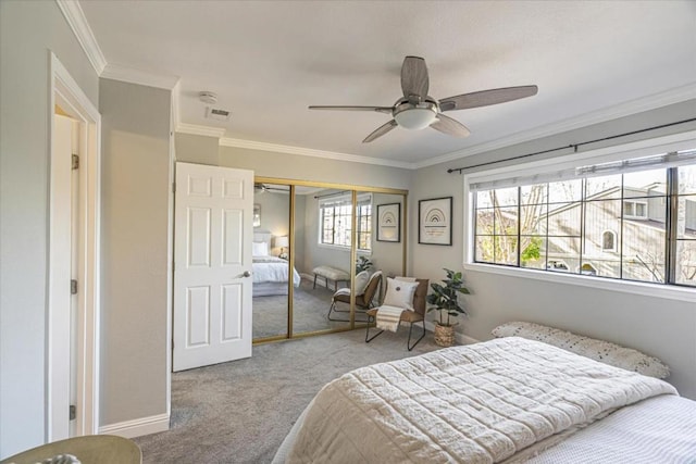 carpeted bedroom featuring ceiling fan, ornamental molding, and a closet