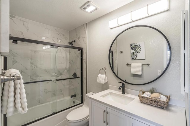 full bathroom with toilet, vanity, and shower / bath combination with glass door