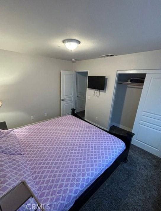 carpeted bedroom featuring a closet