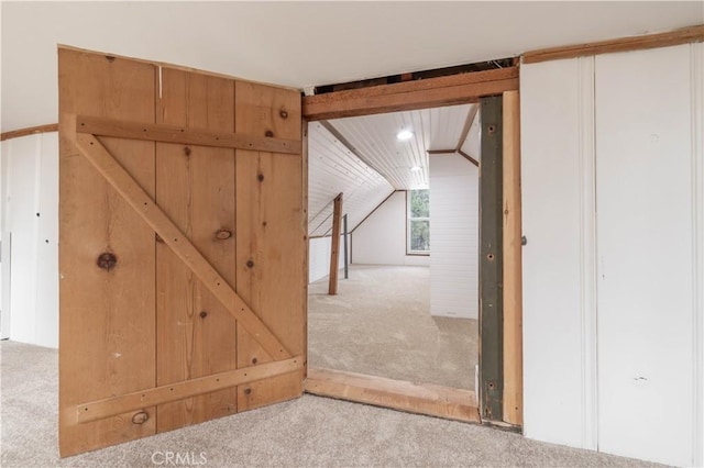 additional living space featuring vaulted ceiling and carpet floors