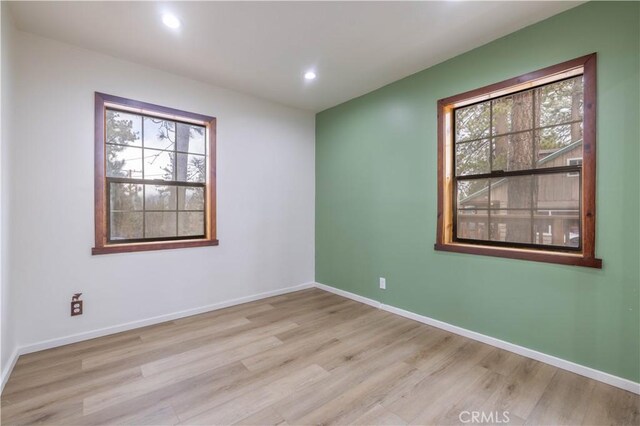 unfurnished room featuring light hardwood / wood-style floors