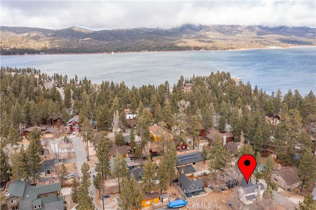 birds eye view of property with a water and mountain view