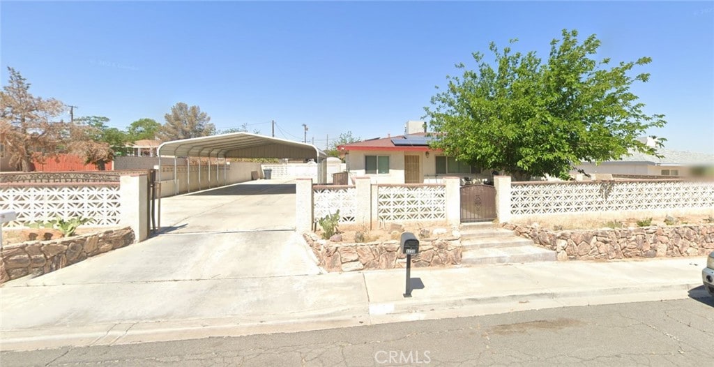 view of front of property featuring a carport