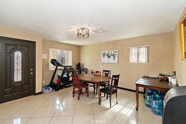 1230 Sunshine Dr, Barstow, CA 92311 - tiled dining space with an inviting chandelier