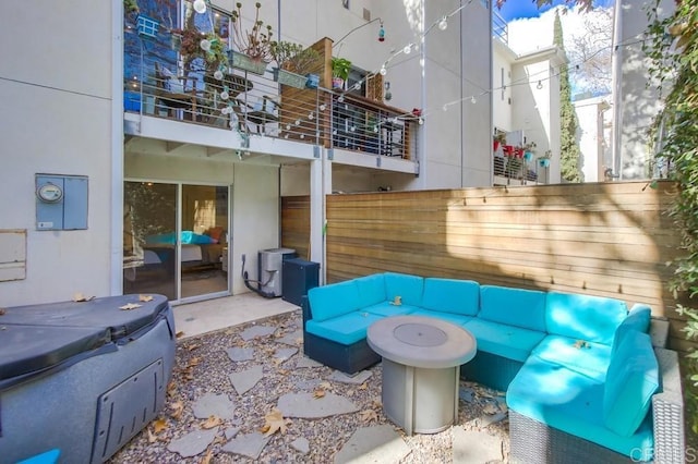 view of patio / terrace featuring an outdoor living space and a covered hot tub