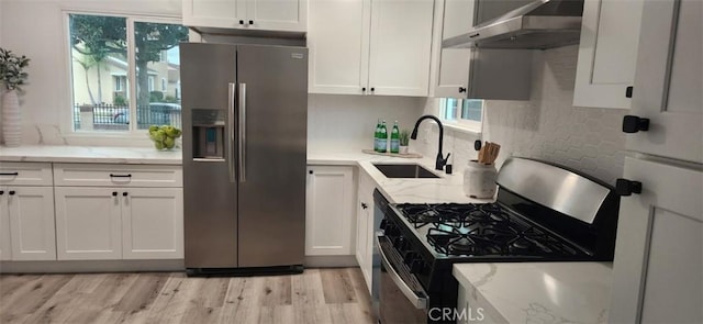 kitchen with refrigerator, sink, white cabinets, gas stove, and stainless steel refrigerator with ice dispenser