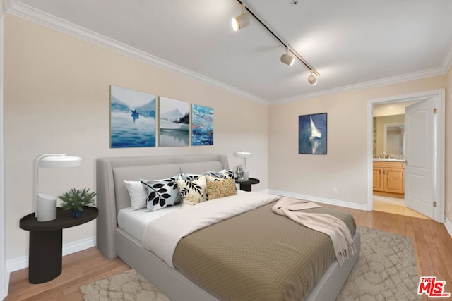 bedroom with ornamental molding, sink, and light wood-type flooring