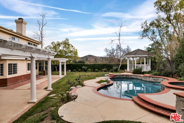 view of swimming pool featuring a gazebo, a pergola, a mountain view, an in ground hot tub, and a patio