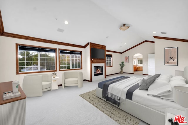 carpeted bedroom with multiple windows, crown molding, and lofted ceiling