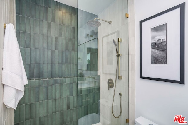 bathroom with tiled shower and toilet