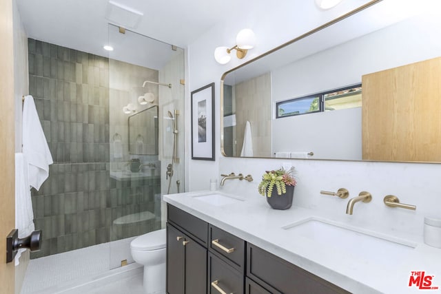 bathroom with vanity, a tile shower, decorative backsplash, and toilet