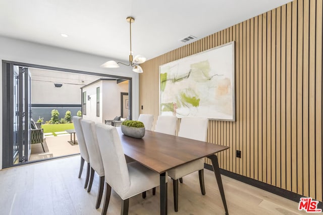 dining area featuring a chandelier and light wood-type flooring