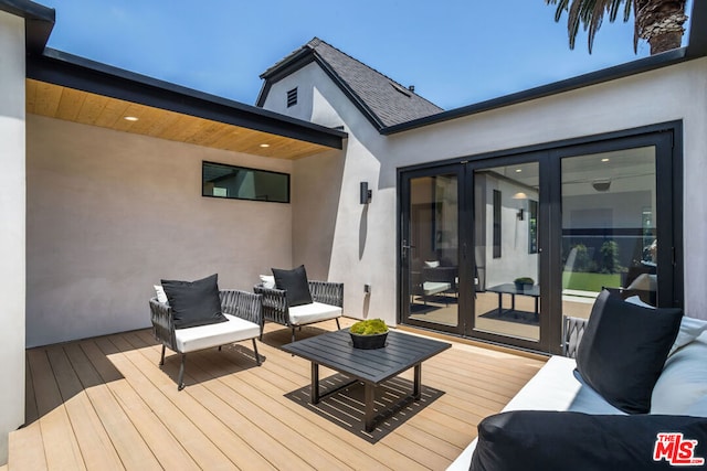 wooden deck featuring outdoor lounge area and french doors