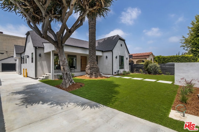 view of front of property with a garage and a front lawn