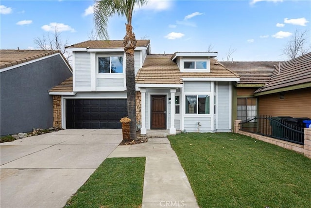 front facade featuring a garage and a front lawn