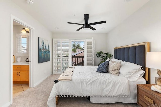 carpeted bedroom featuring ceiling fan, connected bathroom, and multiple windows